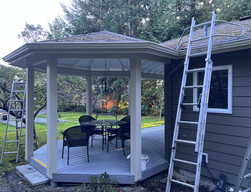 A deck and gazebo extension with newly-replaced fascia and gutter installation
